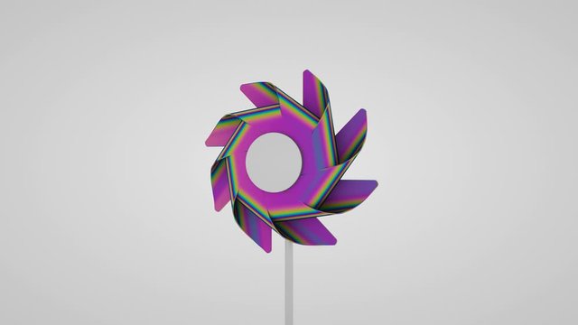 A pinwheel on a holographic foil stick rotates on a white background. Seamless loop.