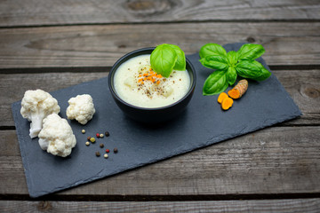 tasty cauliflower soup with fresh turmeric and colored pepper