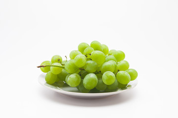 Fresh green grapes on the plate 