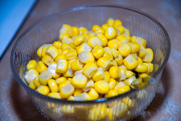 Bowl with tasty yellow corn in a glass bowl