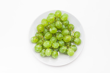 Fresh green grapes on the plate 