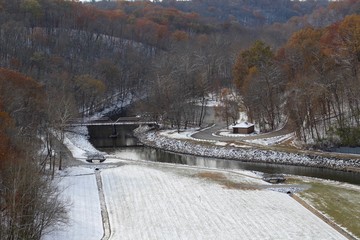 The creek in the snowy valley on a cloudy fall day.