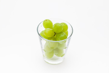  Fresh green grapes with glass cup isolated 