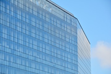 Abstract image of looking up at modern glass and concrete building. Architectural exterior detail of office building. 