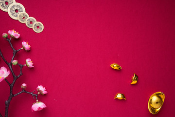 Chinese New Year decorations with red background with assorted festival decorations. Chinese characters means abundant of wealth, prosperity and luck. Flat lay or top view. 