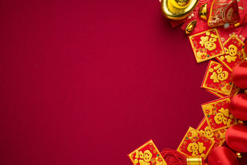 Chinese New Year decorations with red background with assorted festival decorations. Chinese characters means abundant of wealth, prosperity and luck. Flat lay or top view. 