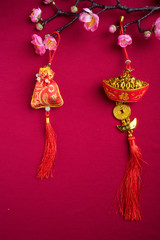 Chinese New Year decorations with red background with assorted festival decorations. Chinese characters means abundant of wealth, prosperity and luck. Flat lay or top view. 