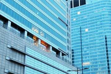 Abstract image of looking up at modern glass and concrete building. Architectural exterior detail of office building. 
