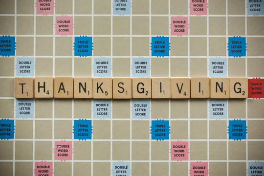 WOODBRIDGE, NEW JERSEY - November 9, 2018: Scrabble tiles spell out the word Thanksgiving on a vintage game board