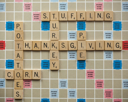 WOODBRIDGE, NEW JERSEY - November 9, 2018: Scrabble tiles spell out various Thanksgiving foods on a vintage board