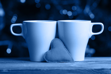 Two mugs on a bokeh background. Valentine day concept