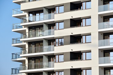 Fototapeta premium Modern apartment buildings on a sunny day with a blue sky. Facade of a modern apartment building.