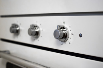 Buttons of the heating temperature, time and cooking mode in the oven.  Kitchen appliances
