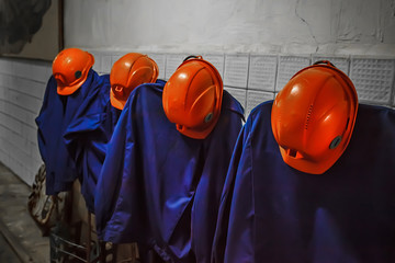 Miner's overalls with orange helmets. Miner's clothing.