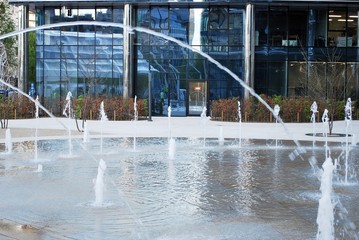 Abstract image of looking up at modern glass and concrete building. Architectural exterior detail of office building. 