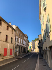 Street with empty road and houses with orange shutters in France