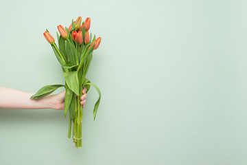 A bouquet of flowers for the holiday. Tulips of red color. Spring flowers. Greeting card for Valentine's Day, Woman's Day and Mother's Day. Copy space.