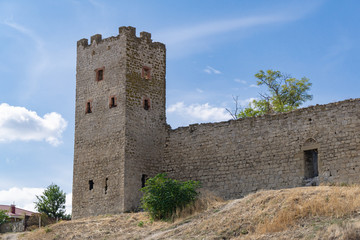 Scenic view of fortification walls of medieval Genoese fortress on Black Sea coast in the southern part of Feodosia city. Feodosia, Crimea, Russia - September, 2019