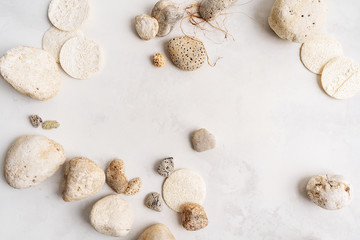 Natural background of minerals, sea, shell, stones, luff, loofah on light concrete surface with copy space  for mockup organic cosmetics.
