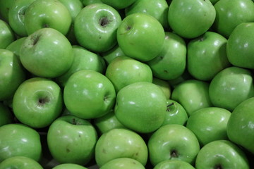 Many ripe green apples on the market