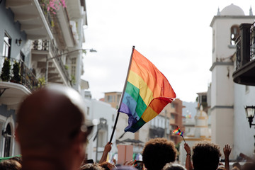 lgbtq+ pride flag waving in the middle of the old town in latin america