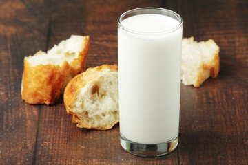 A glass of milk and wheat bread as countryside breakfast	