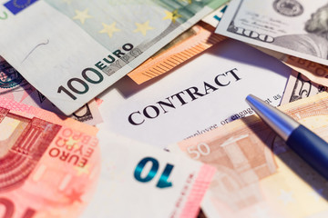 stack hundreds dollars on contract document background