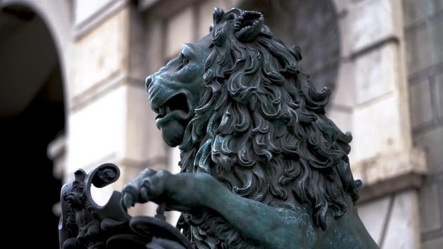 Closeup of lion statue in downtown munich. Famous detail view of so called "Odeonsplatz" in Munich, Bavaria, Germany.