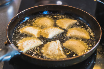 fried Portuguese or Brazilian rissoles in a frying pan