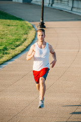 Caucasian man jogging outdoors in the early morning - 313156397