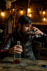 Man with beard holds glass brandy. Macho drinking. Degustation, tasting. Handsome bearded man. Do not drink and drive