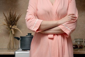 Woman is cooking food on the electric stove on home kitchen.