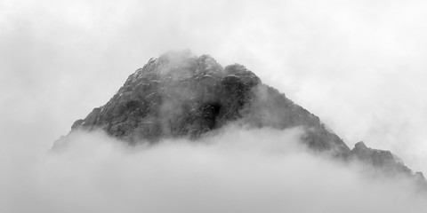 Panoramic black and white view of cloud covered desert mountain peak at Red Rock Canyon National...