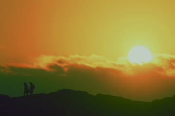 sunset over green field