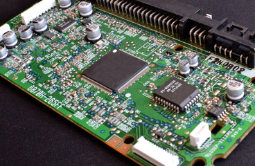 Green motherboard with chips and transistors