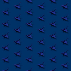 Seamless pattern with origami paper cranes on colored background