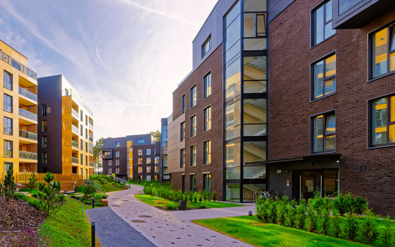 Fototapeta Apartment in residential building exterior. Housing structure at blue modern house of Europe. Rental home in city district on summer. Wall and glass high architecture for business property investment.