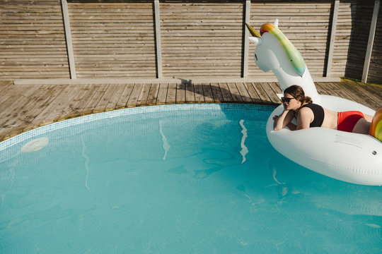 Woman in garden swimming-pool