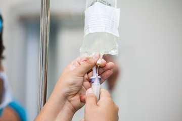Nurse injecting a drug through an infusion system
