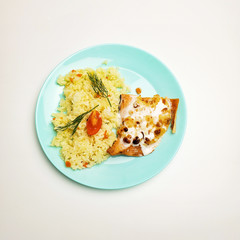 Fried fish steak with white rice on a plate on a white background. fish fillet with rice.