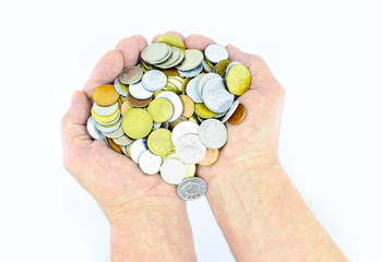 Fototapeta na wymiar Handful of different coins in the hands of a man isolated on a white background. Saving money concept.