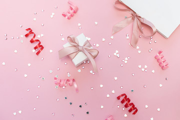 Valentine’s Day gifts on trendy pink pastel background with festive decor and copy space for your text. Festive background.