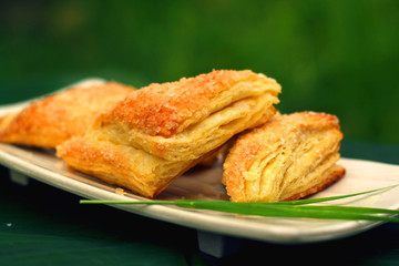 Homemade pastry with topping granulated sugar on a square plate