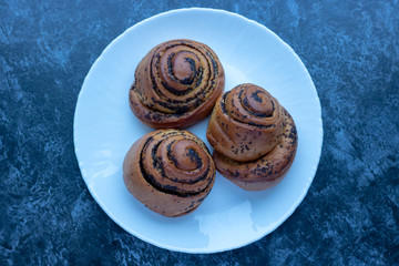 Homemade bun with poppy seeds and sugar, rolls on plate