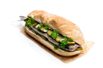 Traditional Dutch sandwich with herring and pickles isolated on white