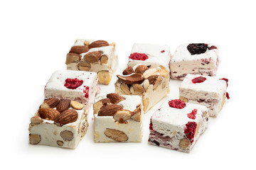 Homemade nougat bars with almonds and dried fruits isolated on white