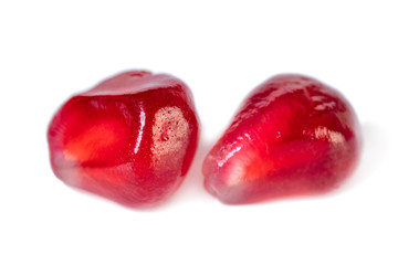 Fresh pomegranate seeds isolated on white background. Close up.