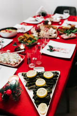 Christmas dinner table with traditional Turkish Cuisine food and red new year concept.	
