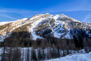Fototapeta na wymiar alpine panorama, snowy mountains with blue sky