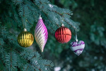 Christmas toys on a Christmas tree under snow